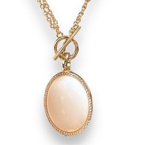 White moonstone lined with white diamonds on a double gold chain.